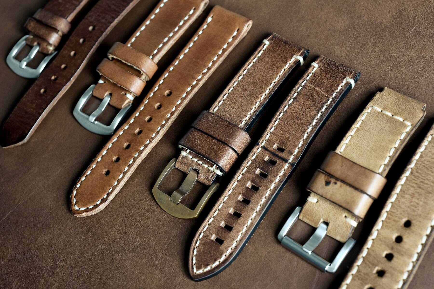 Leather watch straps lined up next to each other.